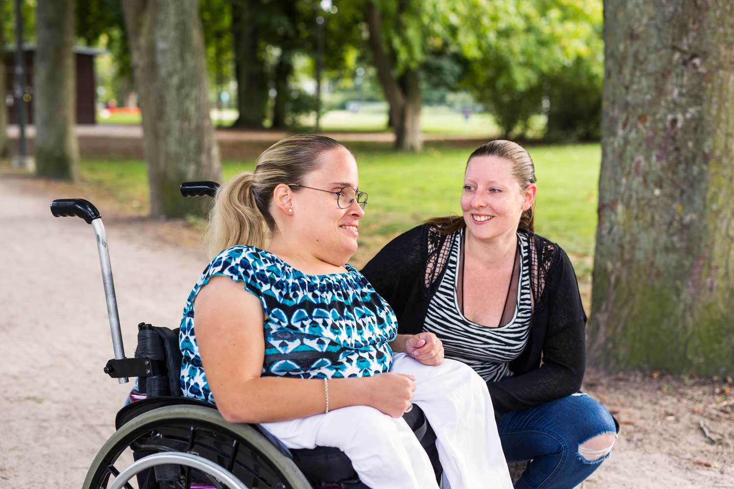 woman-in-wheelchair-with-assistant